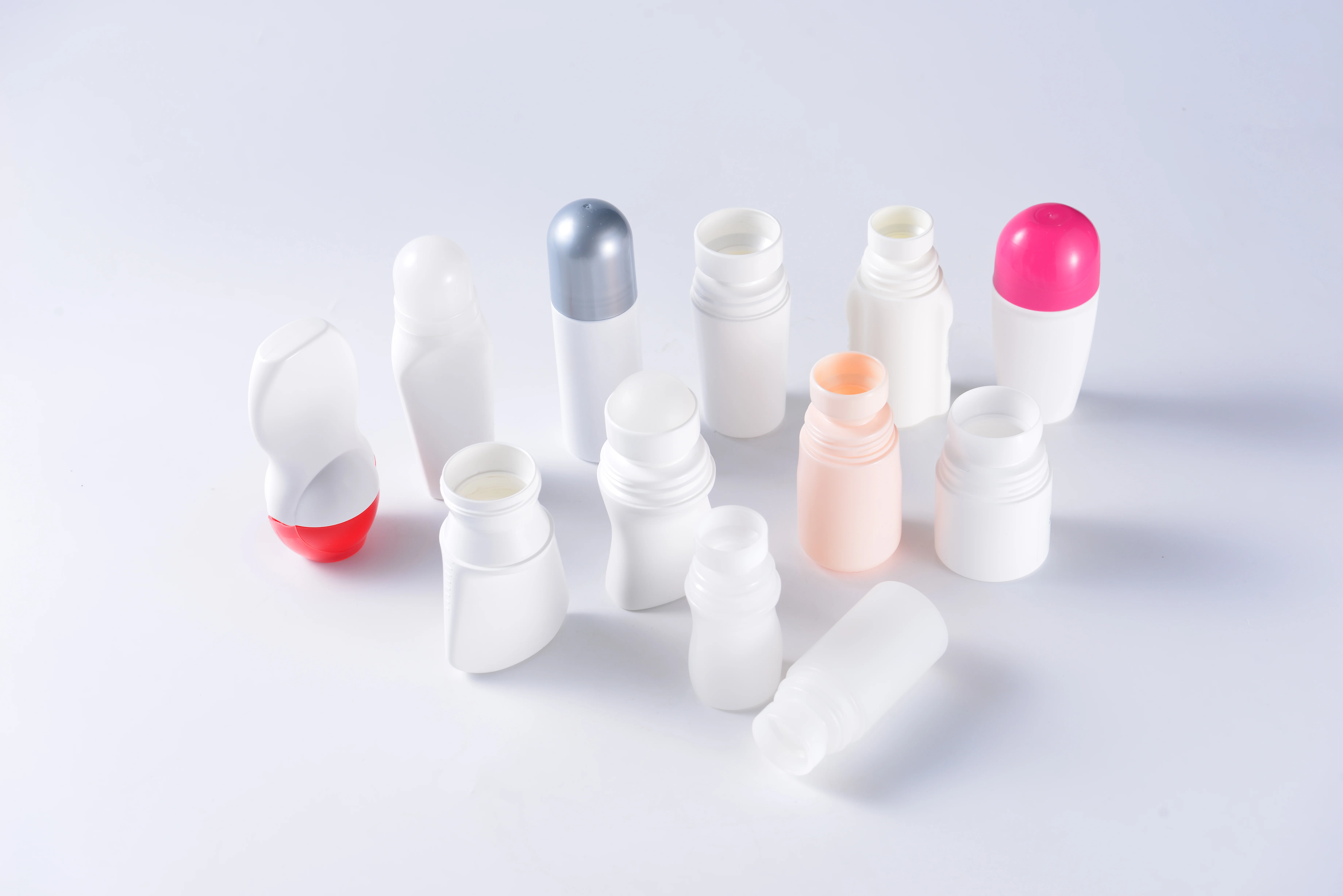 Real white roll-on bottle samples with solid-color caps and varied neck and applicator formats