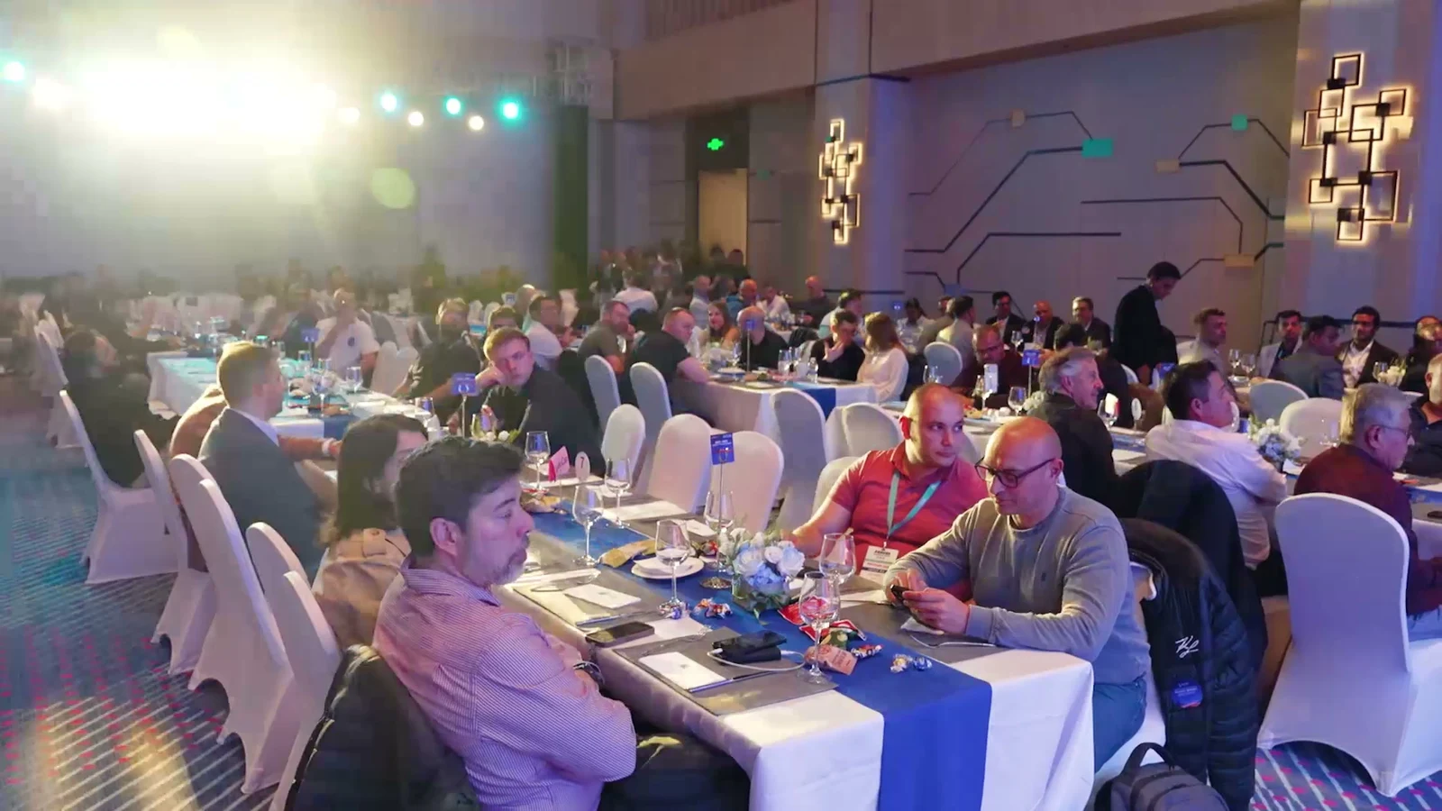 Guests seated together at decorated tables during the LIANXIN evening gathering