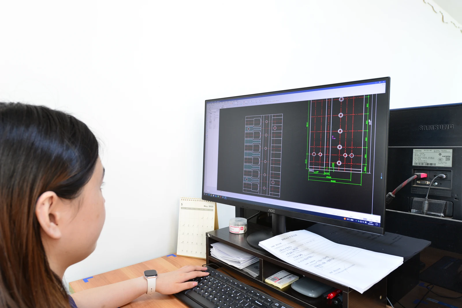 LIANXIN engineer reviewing a technical drawing at a workstation