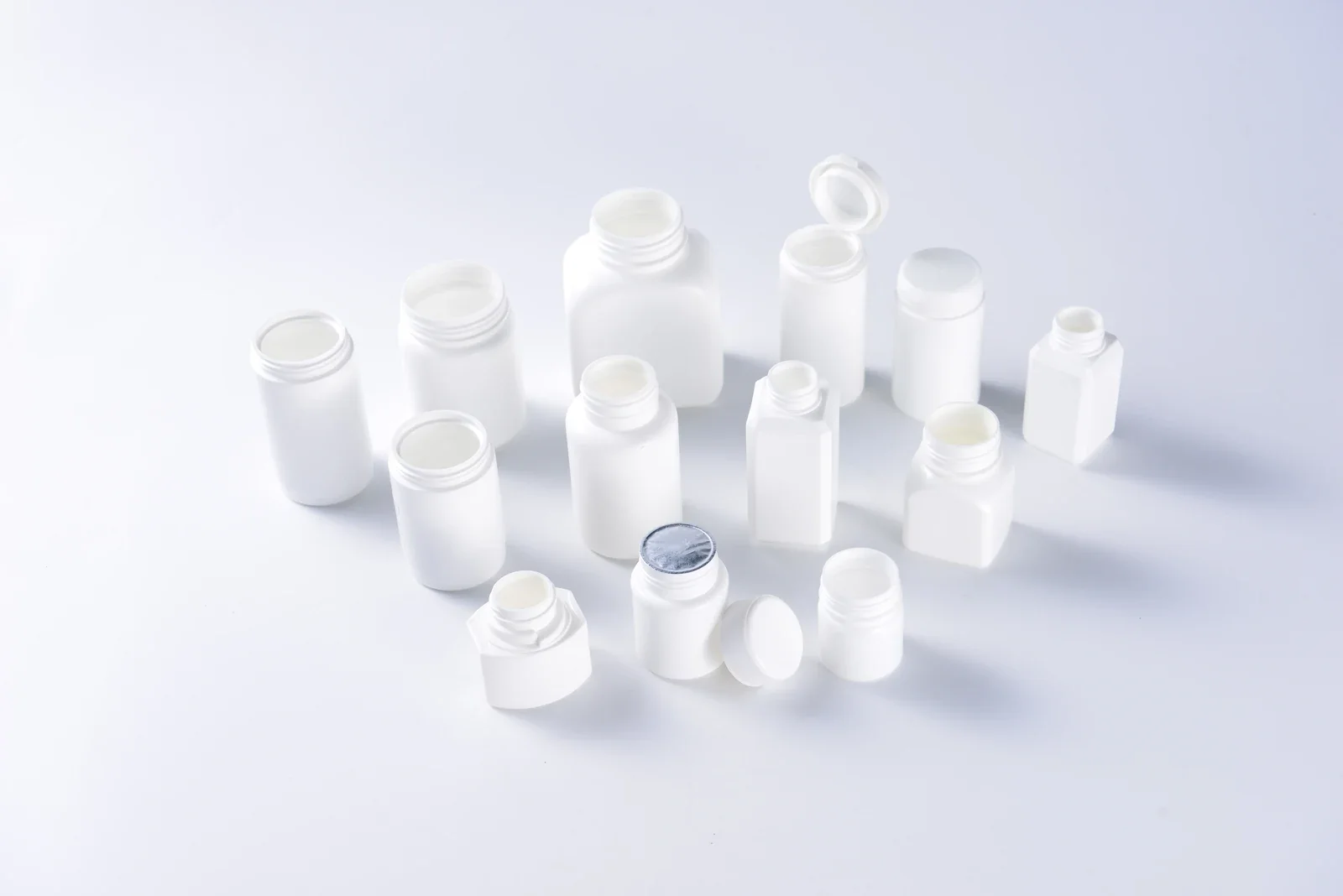 White medicine bottle and container samples in round and rectangular formats