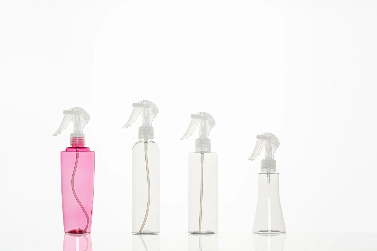 Pink and clear bottle samples fitted with trigger sprayers